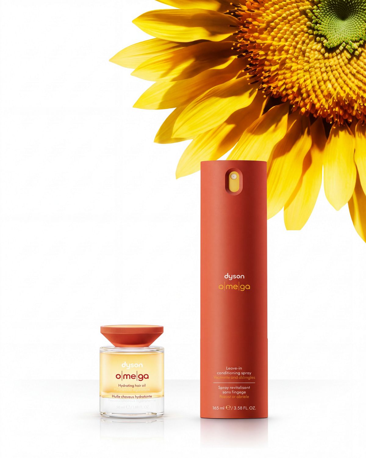 The Dyson Omega nourishing range next to the head of a sunflower.