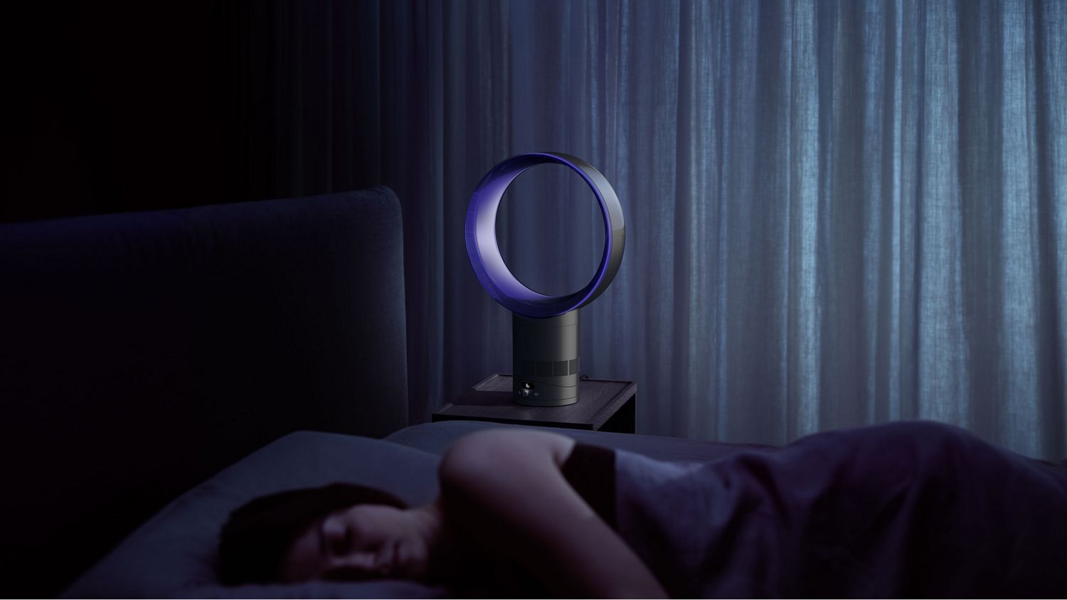 The Dyson Cool CF1 fan cooling a sleeping person with airflow.