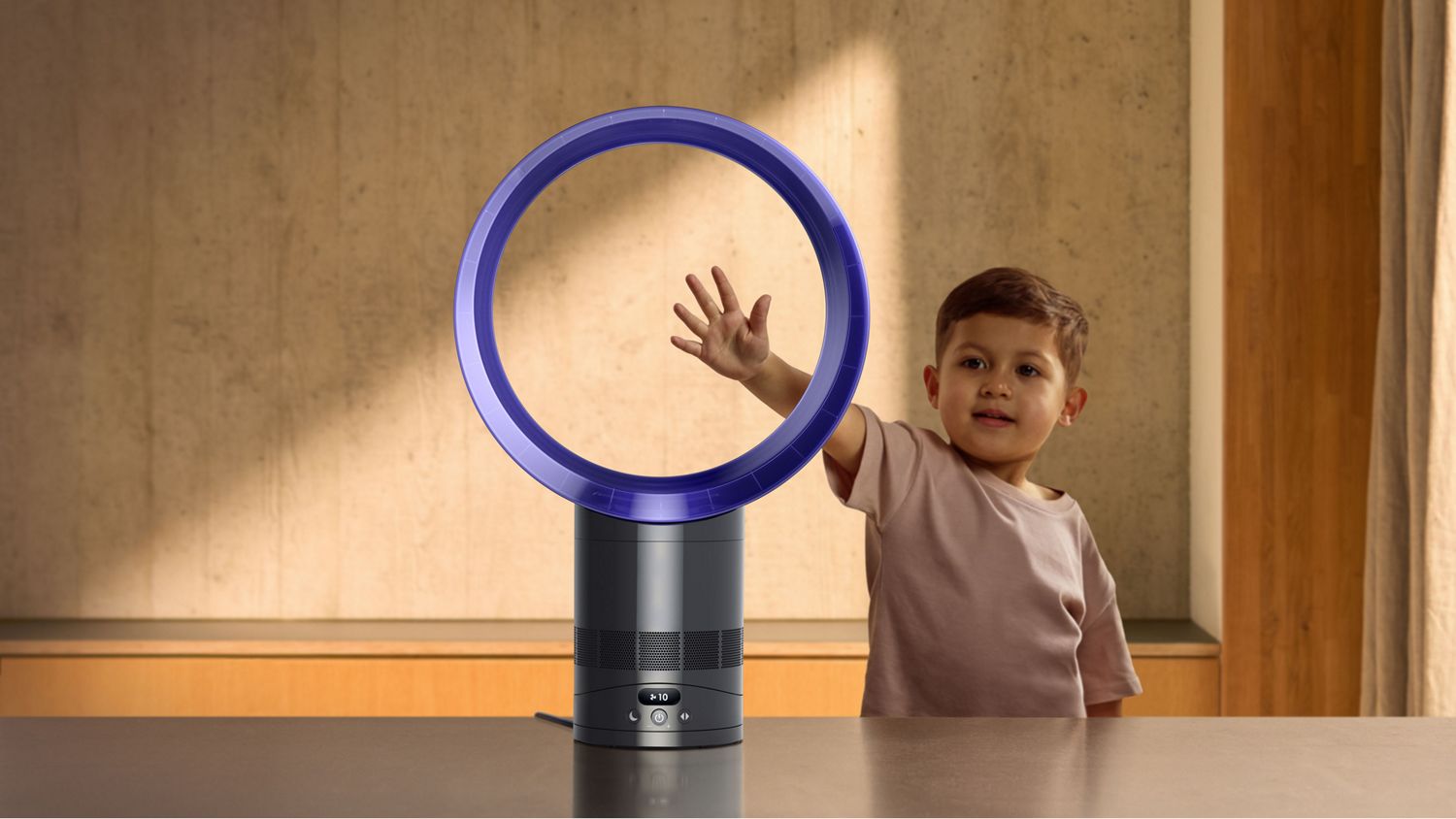 A child feeling the airflow of the Dyson Cool CF1 fan without blades.