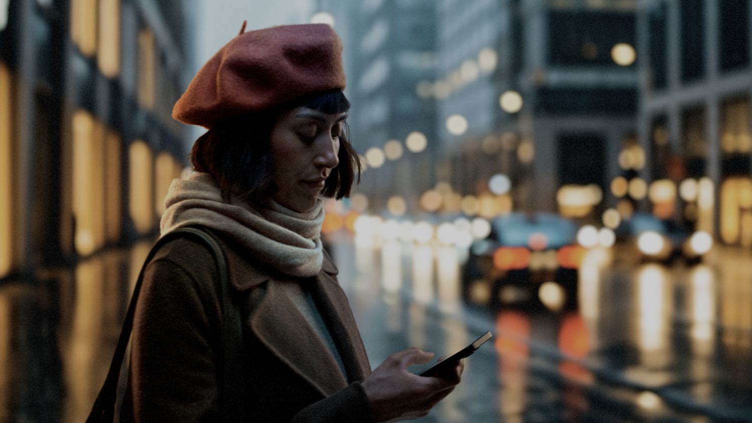 A woman controls her Dyson Hot+Cool HF1 Remote Link Pre-heat fan heater through the MyDyson app as she leaves work.