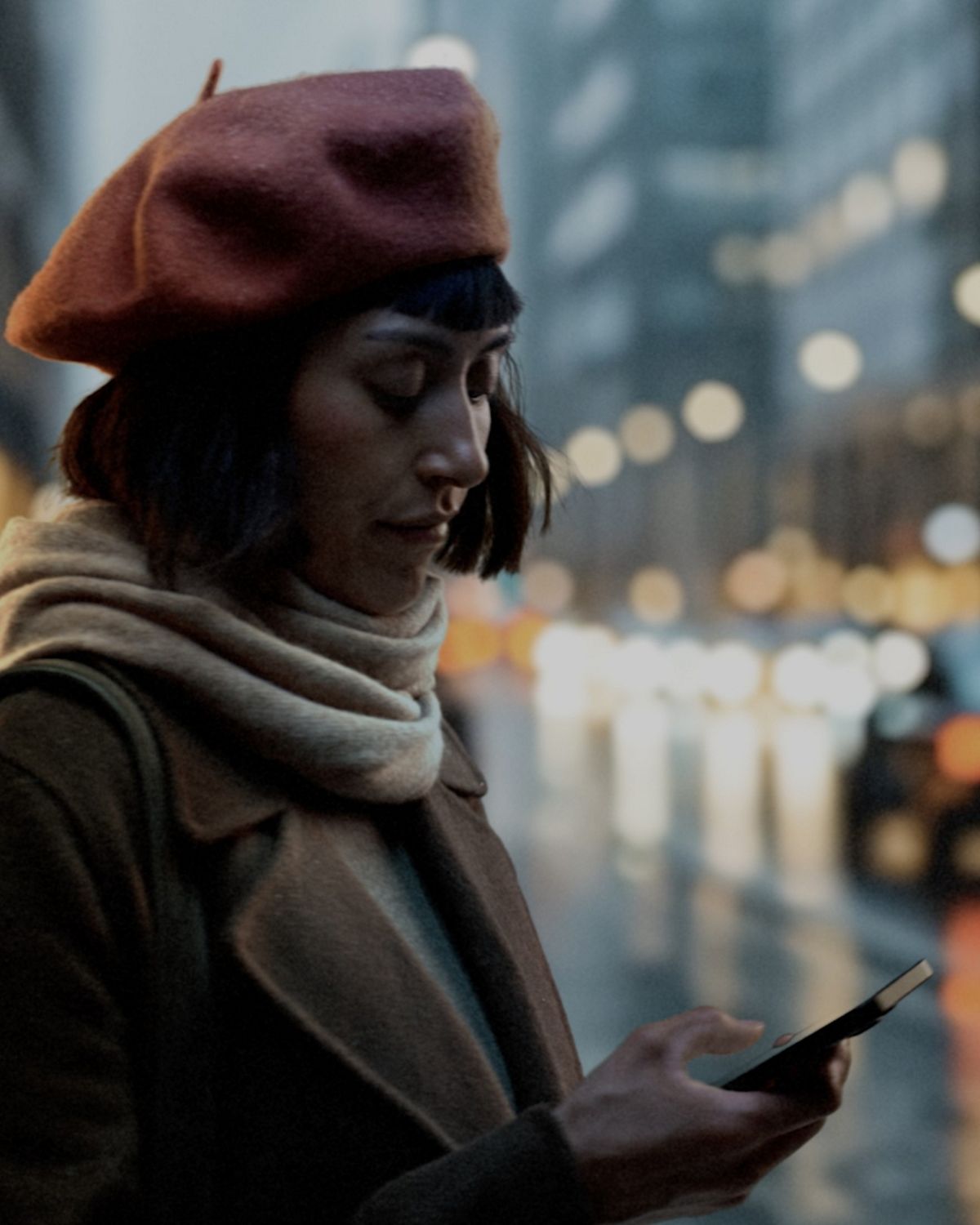 A woman controls her Dyson Hot+Cool HF1 Remote Link Pre-heat fan heater through the MyDyson app as she leaves work.