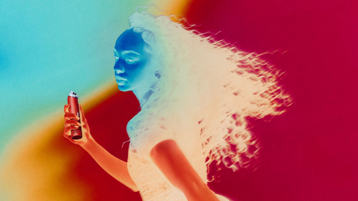 Model cools down using the Dyson HushJet Mini Cool portable fan.