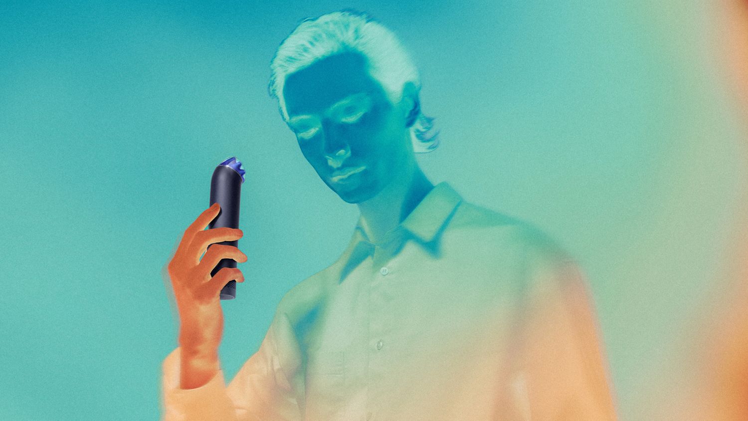 Model cools down using the Dyson HushJet Mini Cool portable fan.