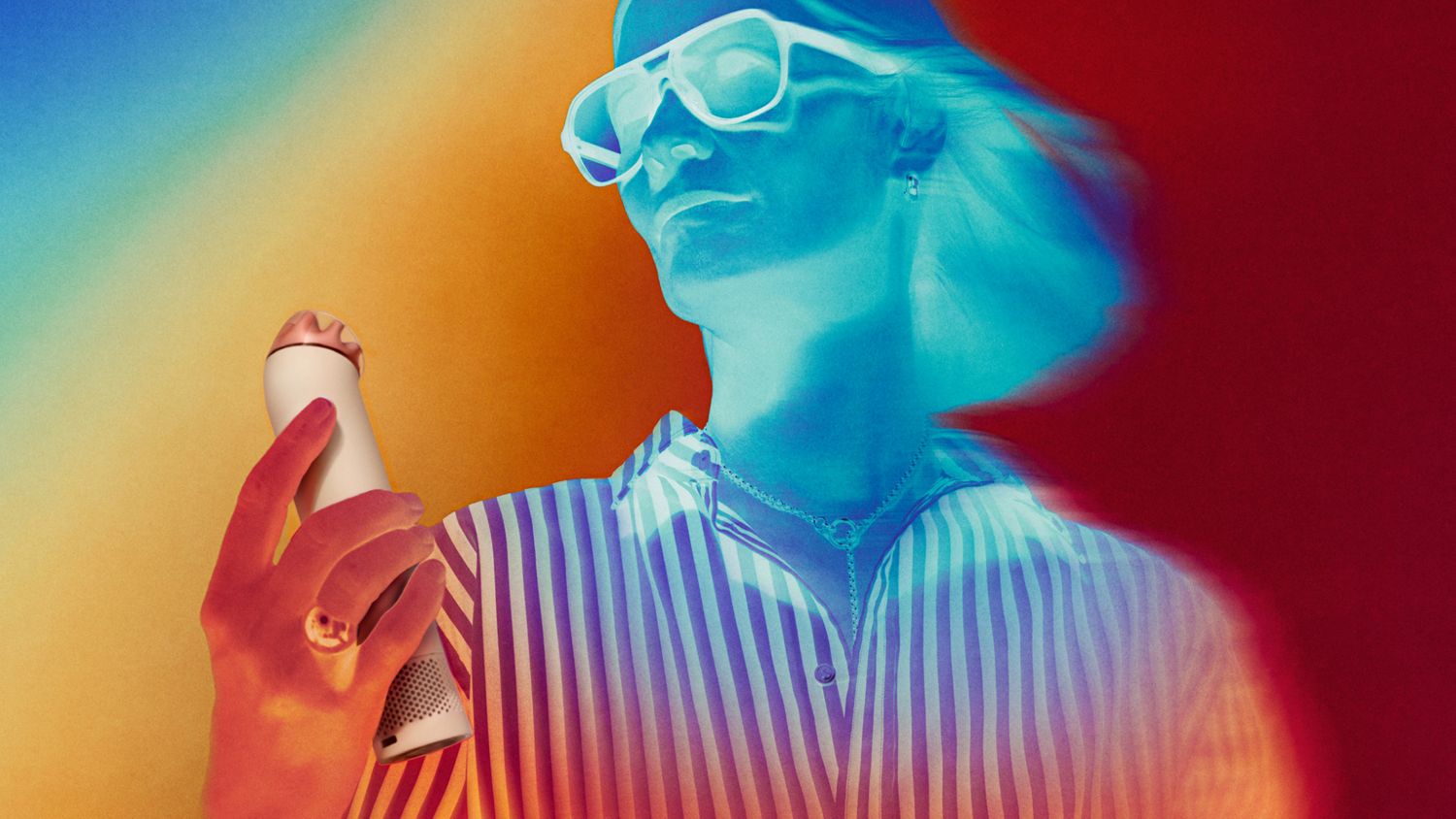 Model cools down using the Dyson HushJet Mini Cool portable fan.