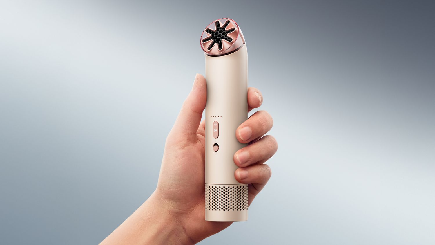 The Dyson HushJet Mini Cool portable fan held upright in a hand.
