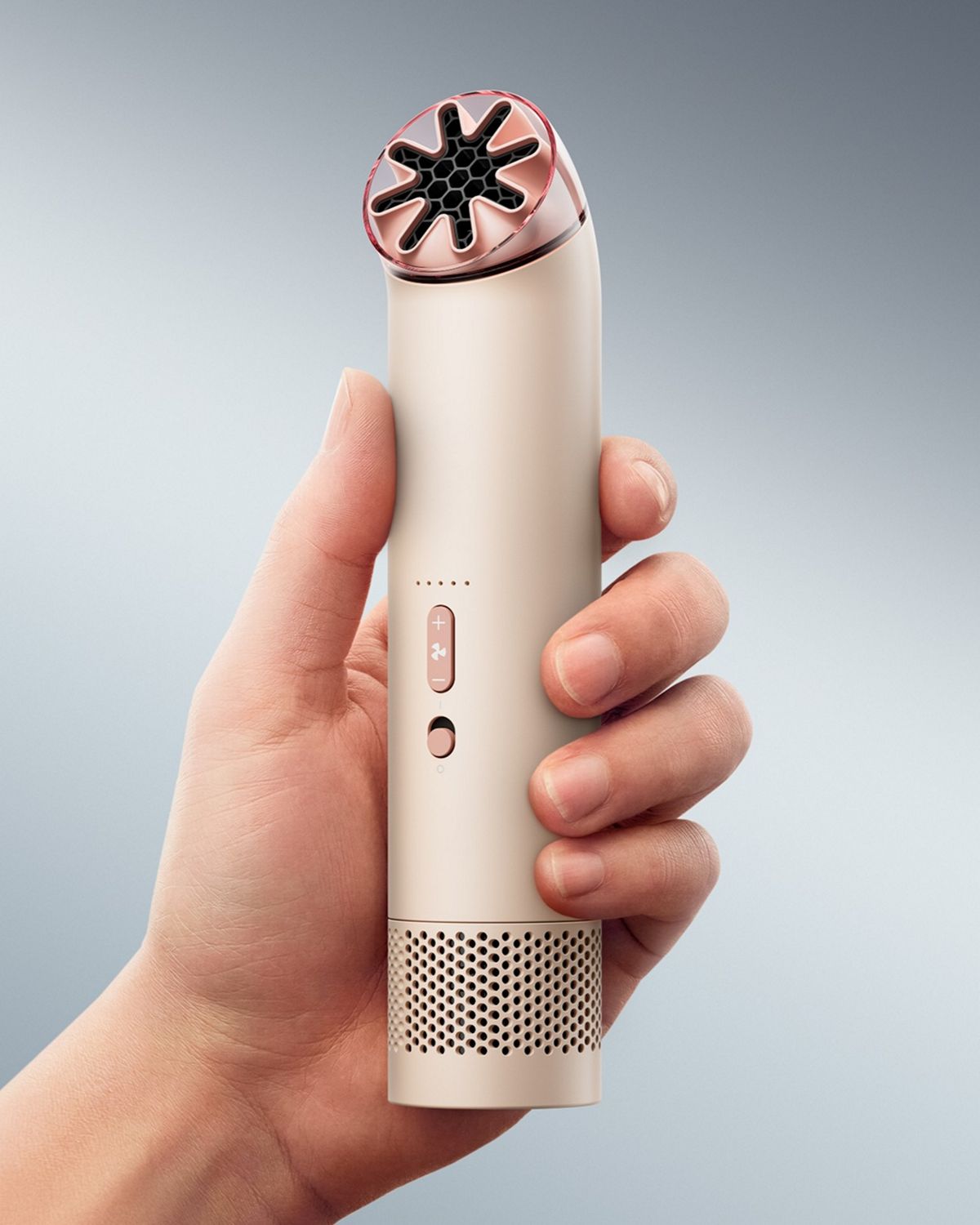 The Dyson HushJet Mini Cool portable fan held upright in a hand.