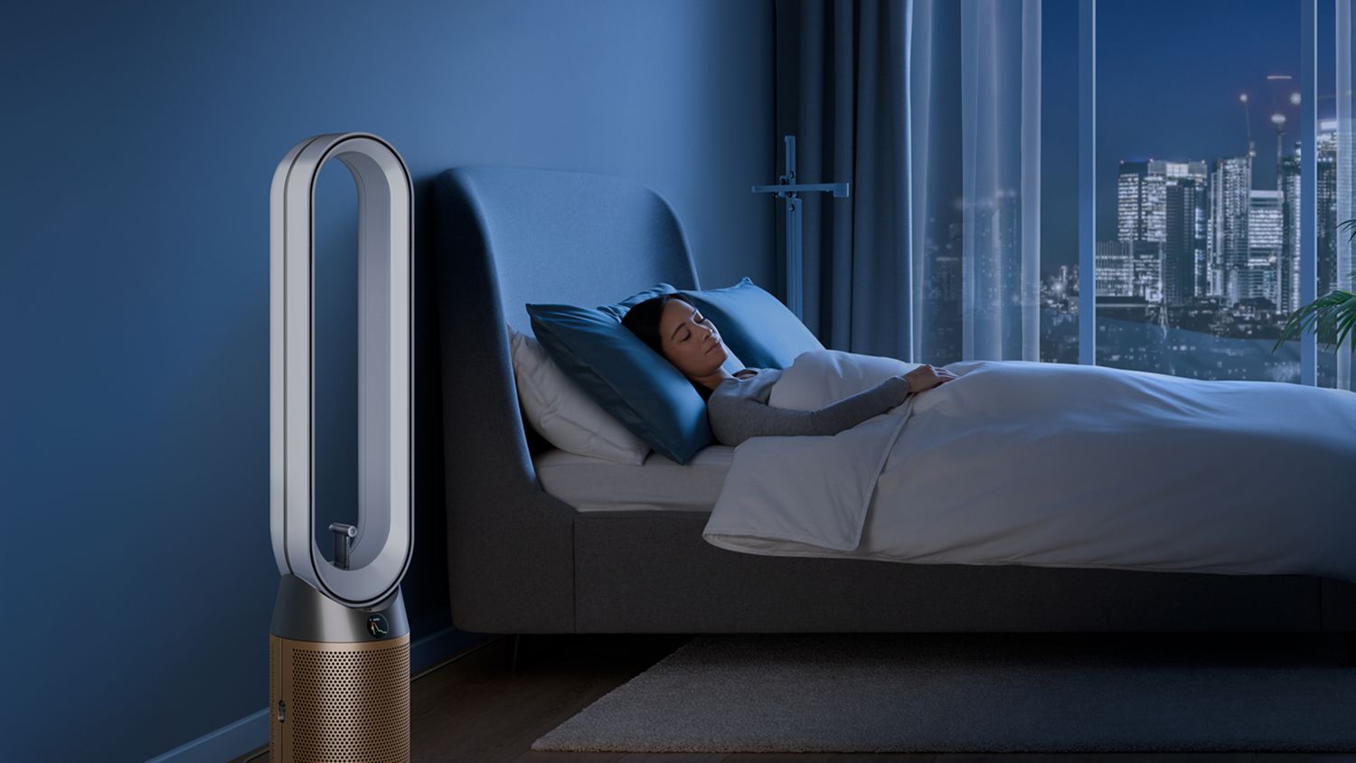 A person sleeps next to their Dyson Find+Follow Purifier Cool fan.