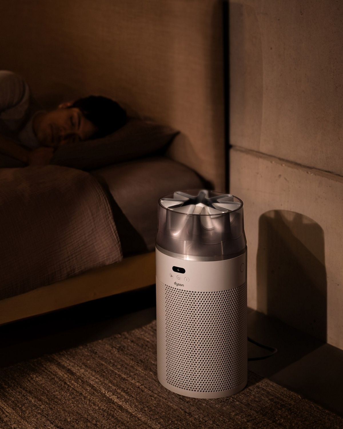 Dyson Hushjet shizuka空気清浄機が、寝ている人のそばの寝室で稼働。グラフが時間経過による空気の質を表示している様子。