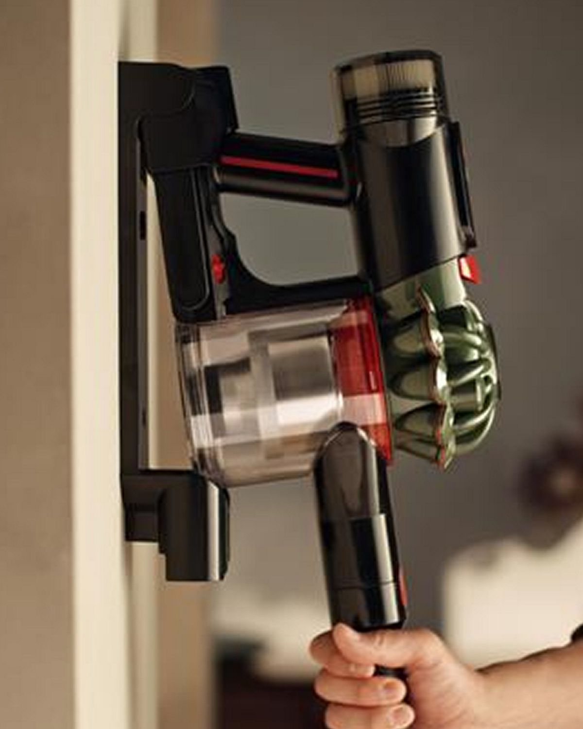 The Dyson V8 Cyclone vacuum is returned to its charging dock.