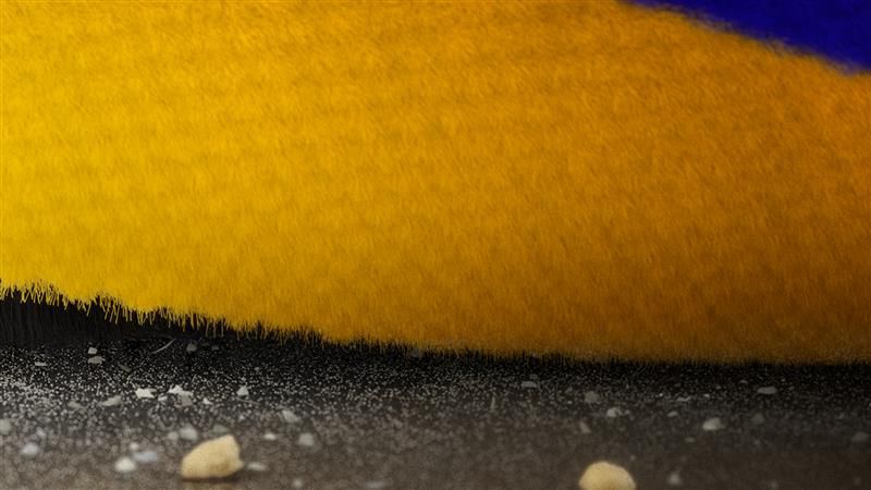 Fluffy Opticクリーナーヘッドのブラシバーが床の隙間を掃除している様子
