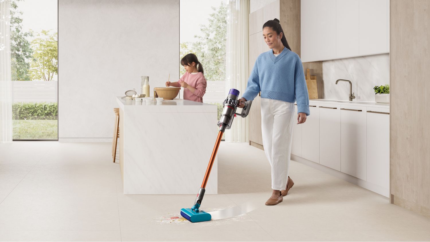 Dyson Cyclone V10 Submarine wet and dry vacuum cleaner used to clean a kitchen floor.