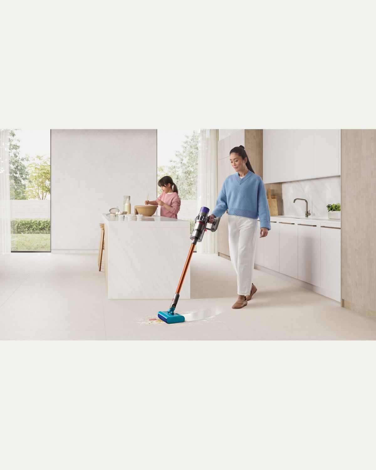 Dyson Cyclone V10 Submarine wet and dry vacuum cleaner used to clean a kitchen floor.