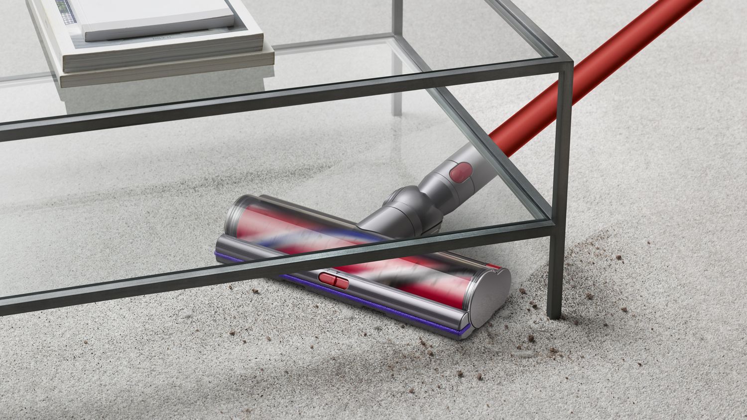 The Dyson Outsize vacuum cleaning under furniture