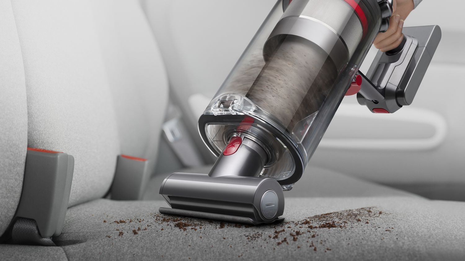 Dyson Outsize vacuum in handheld mode cleaning a car seat.