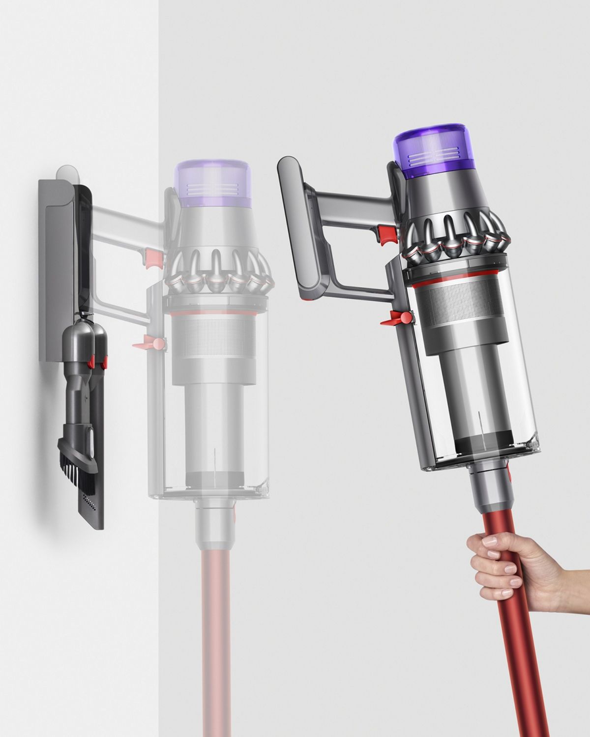 Woman placing Dyson Outsize vacuum into wall charging dock