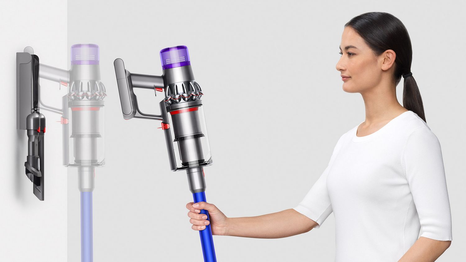 A Dyson V11 cordless vacuum being placed on the wall dock