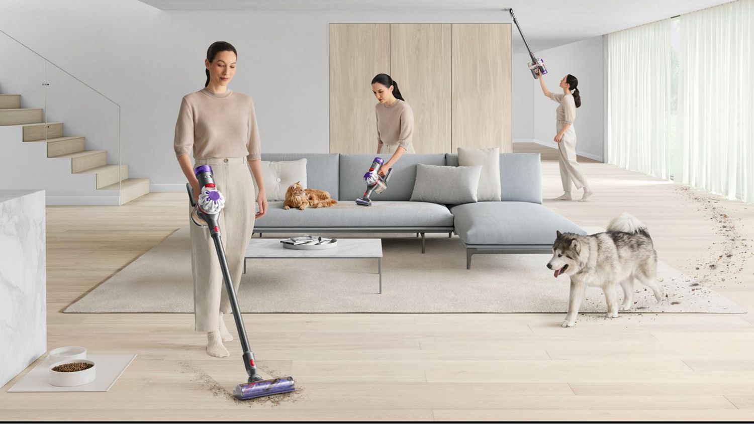 A Dyson V8 vacuum cleaner is used by a pet-owner to clean around her home.