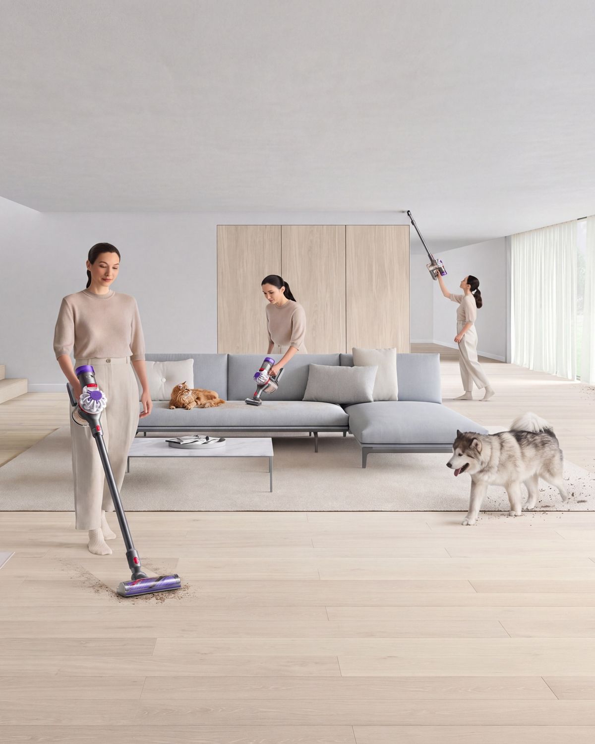 A Dyson V8 vacuum cleaner is used by a pet-owner to clean around her home.