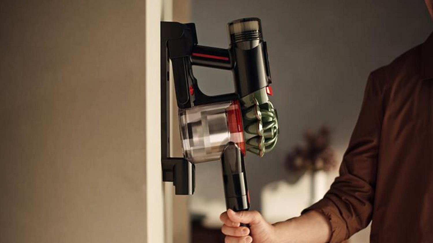 Dyson V8 Cyclone cordless vacuum on its wall-mounted dock.