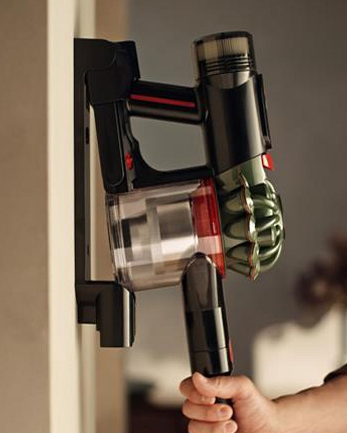 Dyson V8 Cyclone cordless vacuum on its wall-mounted dock.