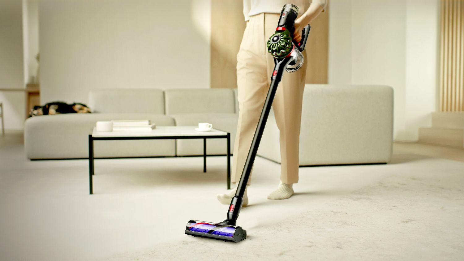 The Dyson V8 Cyclone vacuum used to clean floors in a living room.