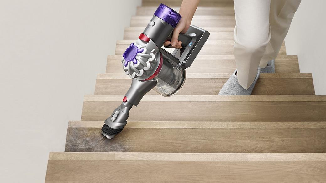 Dyson V8 Focus Clean handheld vacuum used to clean carpeted stairs.