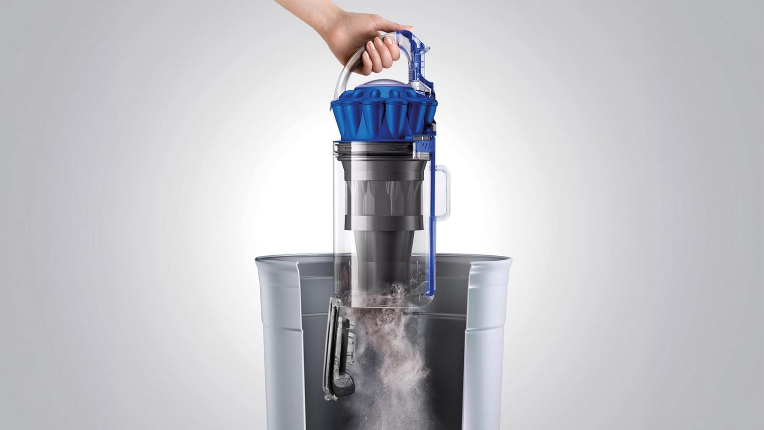 The bin of the Dyson Ball Animal Origin vacuum is emptied.