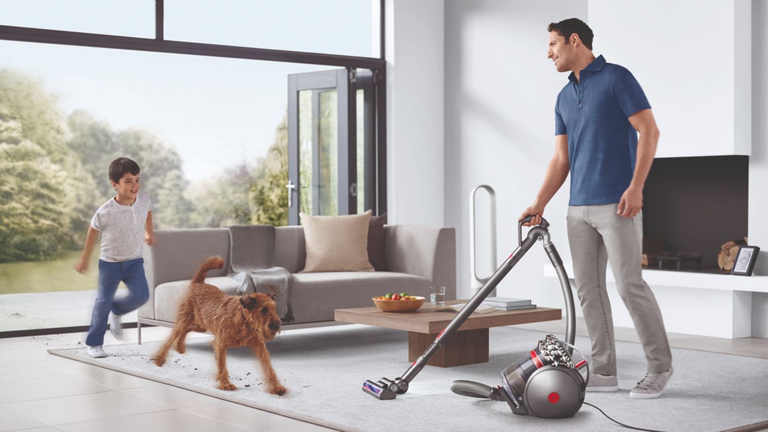 Dyson Big Ball Turbine canister vacuum cleaning a living room floor.