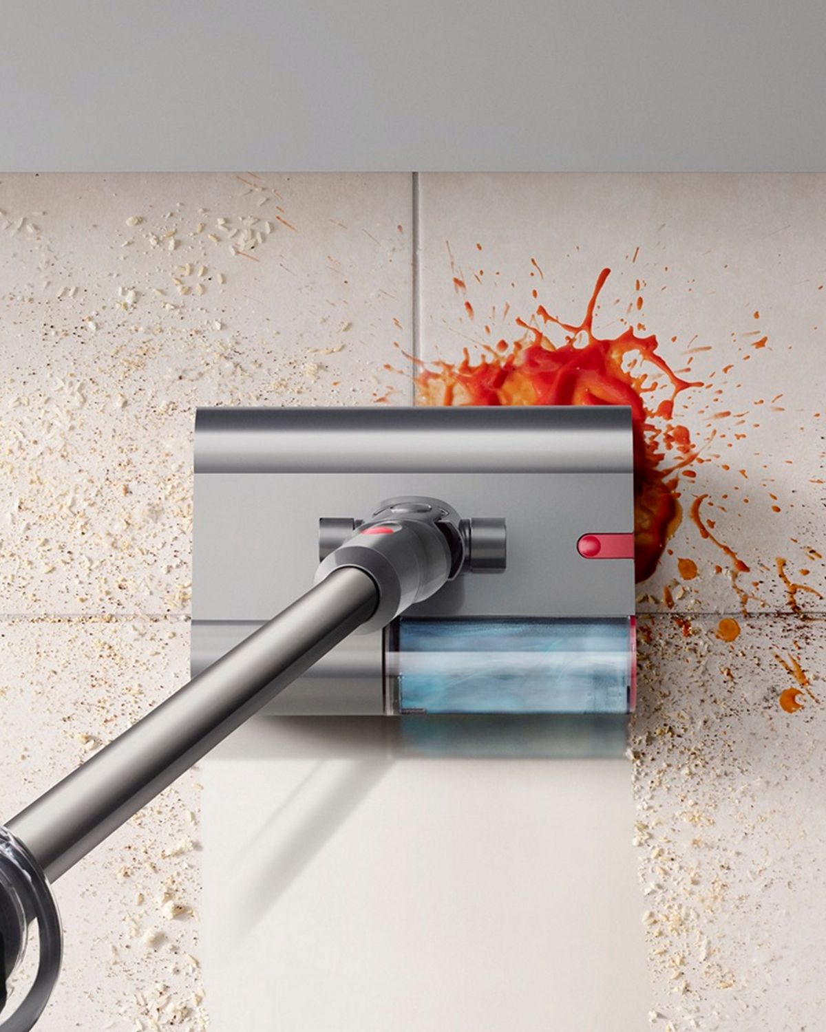 The Dyson V12s Detect Slim Submarine wet and dry vacuum cleaning a spill in the kitchen.