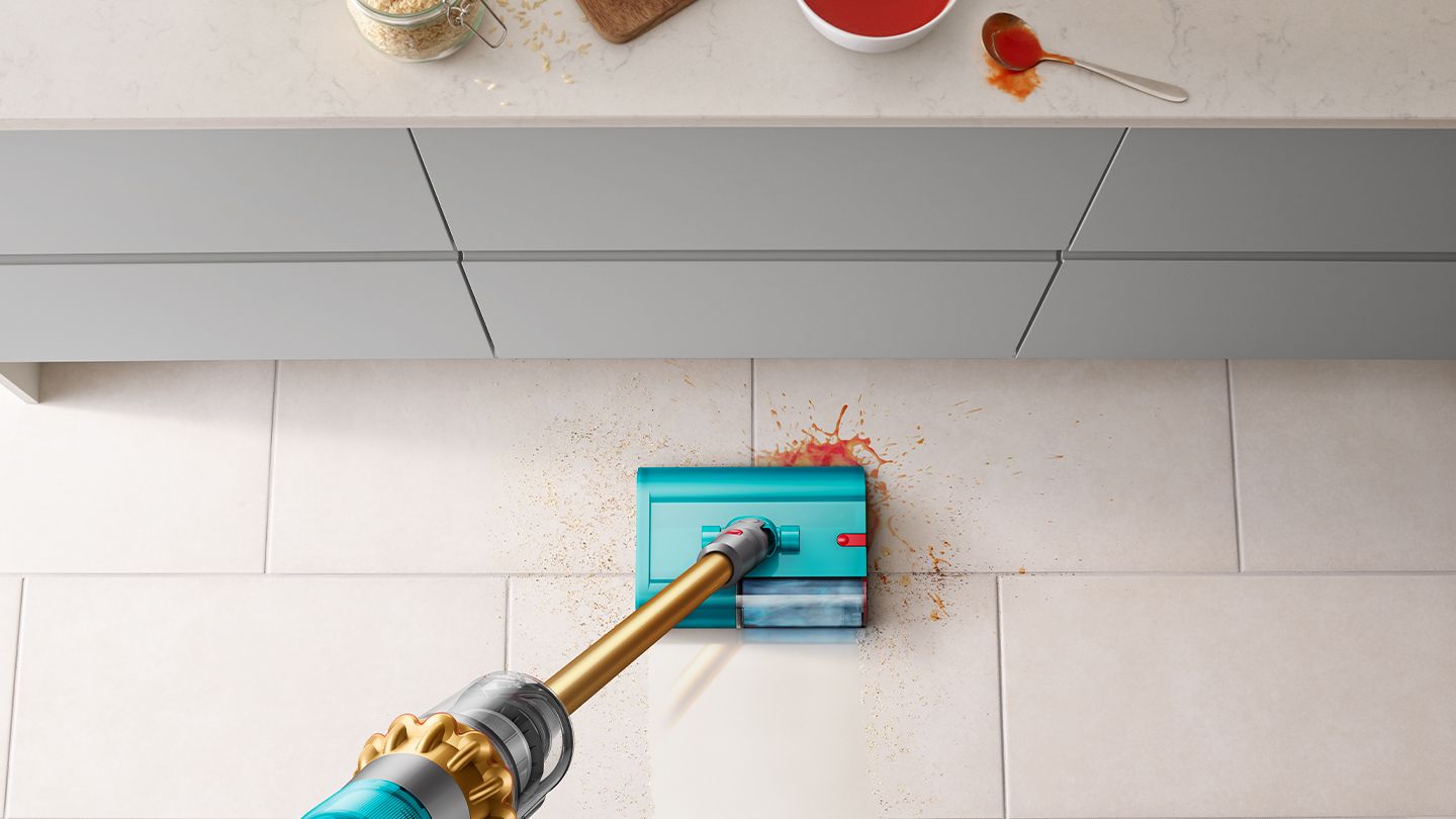 Submarine wet cleaner head picks up debris from hard floor.