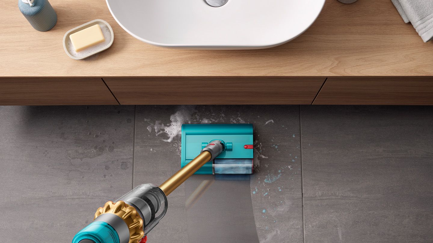 Submarine wet cleaner head picks up debris from bathroom floor.