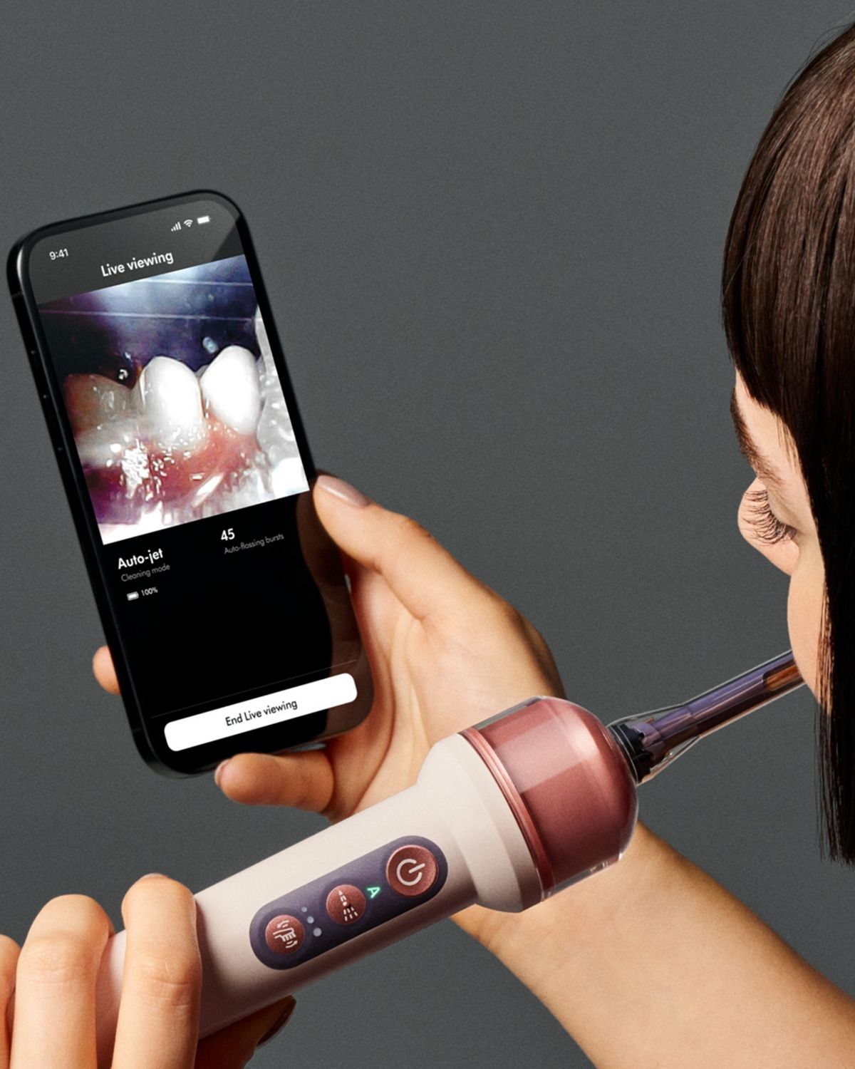 A person uses the MyDyson app and the Dyson CameraJet toothbrush.
