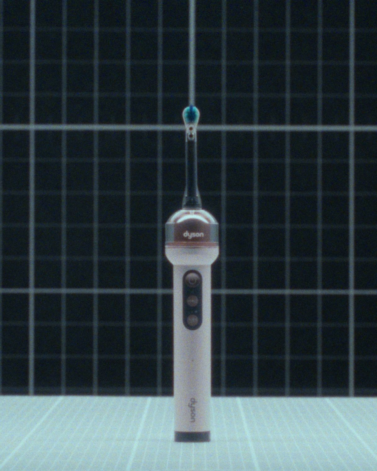 Dyson CameraJet toothbrush suspended in the air.