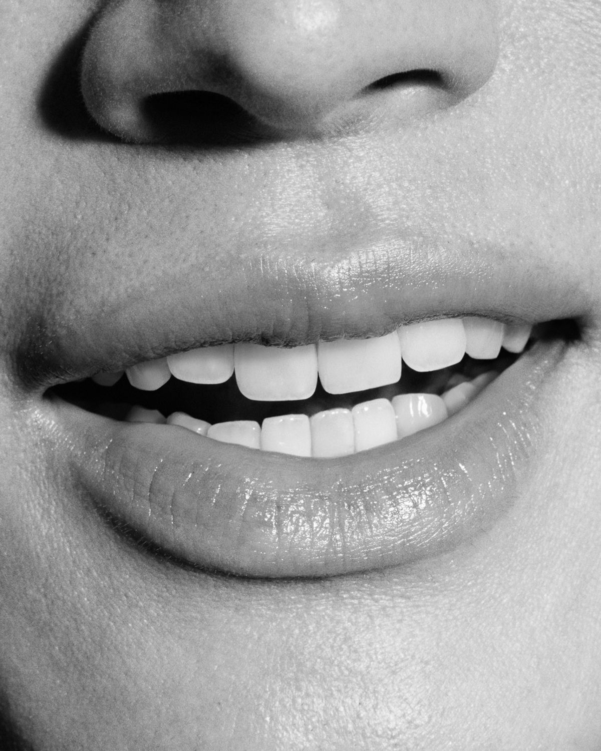 A person smiles to show their healthy white teeth.