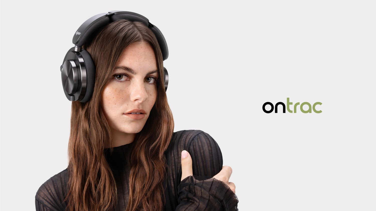 Model wearing the Dyson OnTrac headphones next to the OnTrac logo.