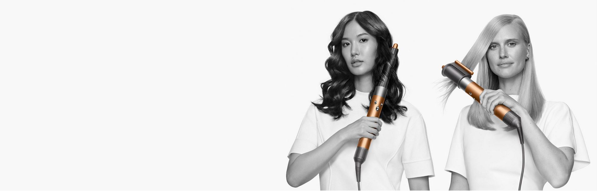 Two women styling their hair with they Dyson Airwrap mutli-styler