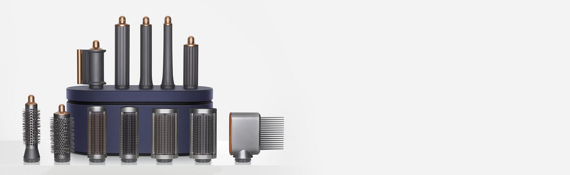 All of the up to date Dyson Airwrap multi-styler attachments displayed around the Storage case.