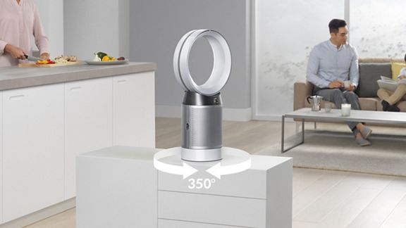 Ventilateur purificateur Dyson Pure Cool posé au milieu de la pièce; l’image est annotée d’un symbole 360 degrés montrant l’oscillation de gauche à droite. 