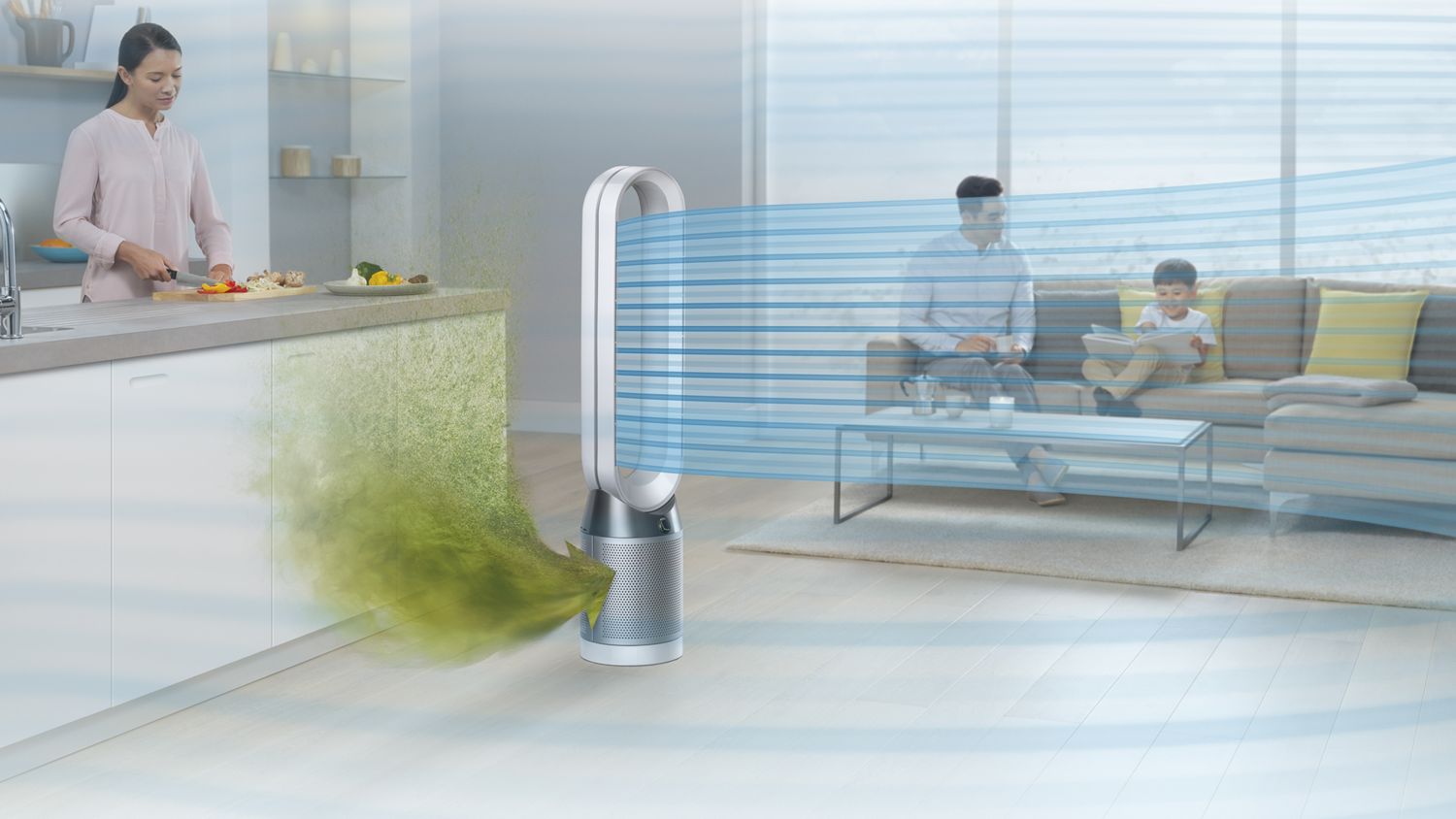Un ventilateur purificateur Dyson Pure Cool posé dans une cuisine capte les polluants et projette de l’air purifié pendant que quelqu’un cuisine en arrière-plan. 