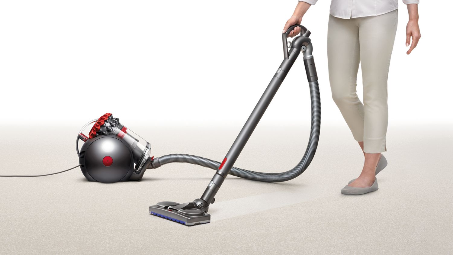 Aspirateur traîneau Dyson Big Ball ramassant des débris sur du tapis.