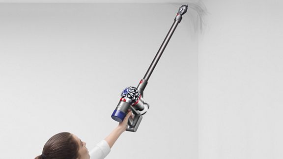 Dyson V7 Motorhead cordless vacuum cleaner removing cobweb from hard to reach area.