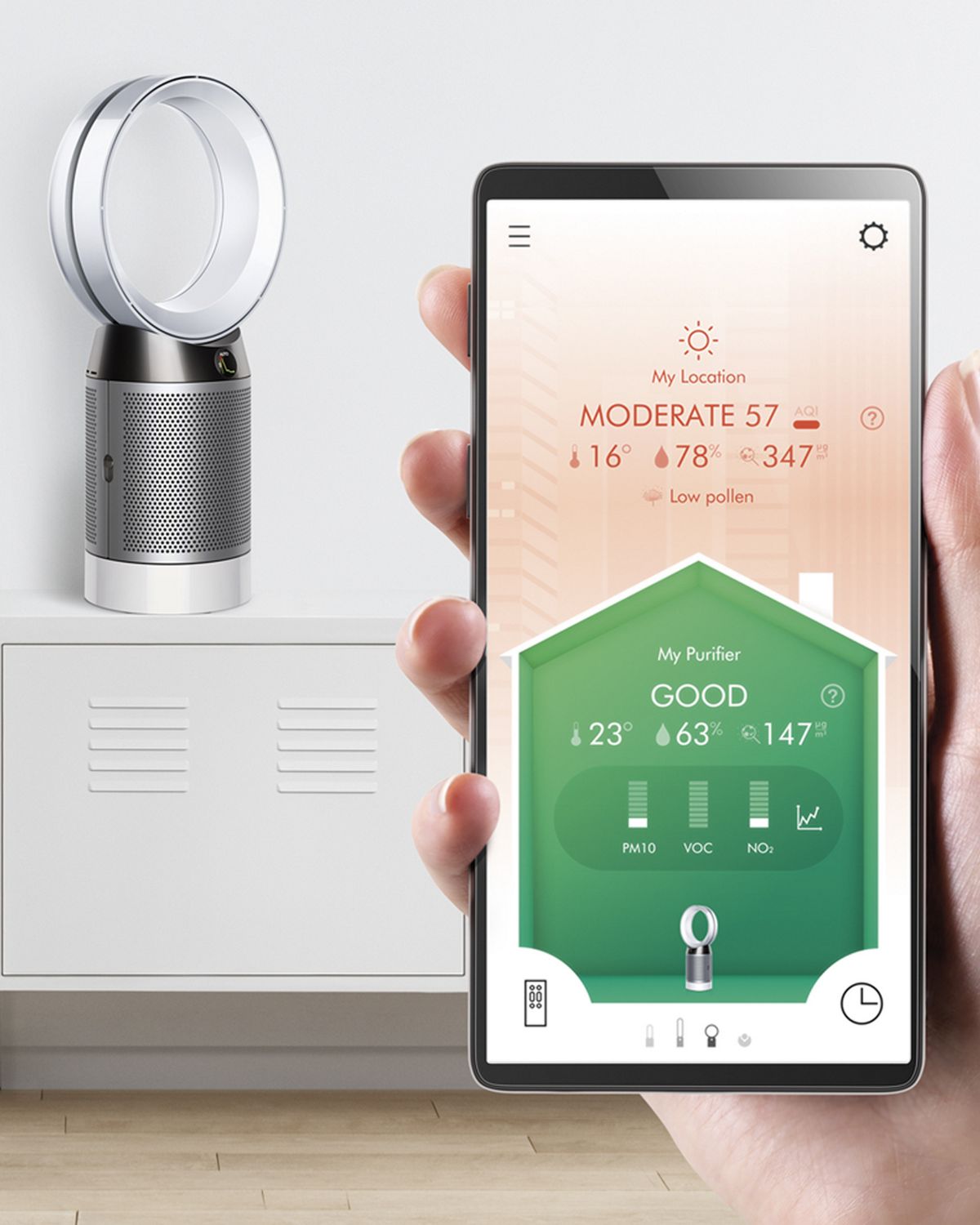 A user holding up the Dyson Link App to control their Dyson Pure Cool purifier fan in the background. 