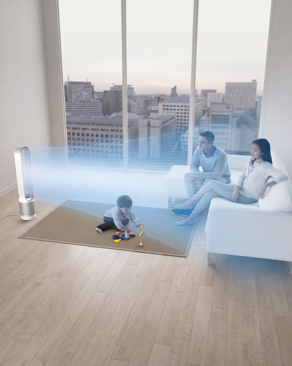 The Dyson Pure Cool purifier fan in the center of a family living room, while a child plays.The blue streams emanating from its loop show the projection of purified air around the room. 