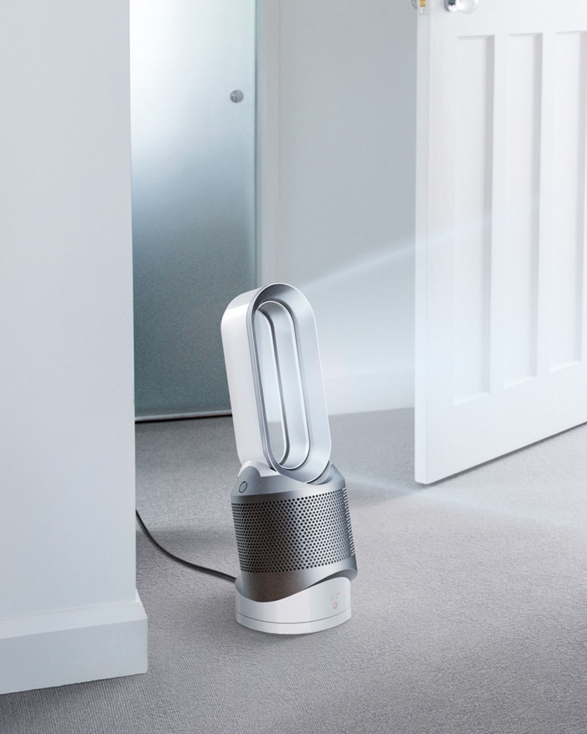 Woman changes baby as the Dyson Hot + Cool purifier purifies the air around them. 