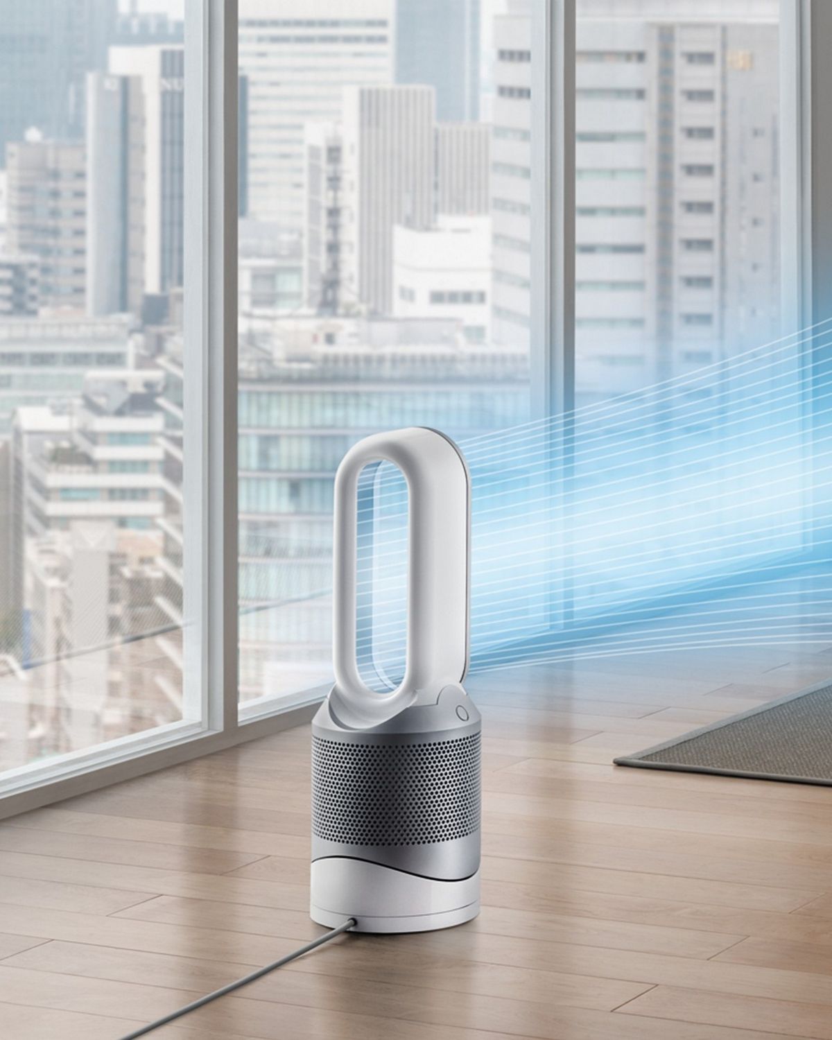 Woman relaxes on sofa as the Dyson Hot + Cool purifier cools the air.