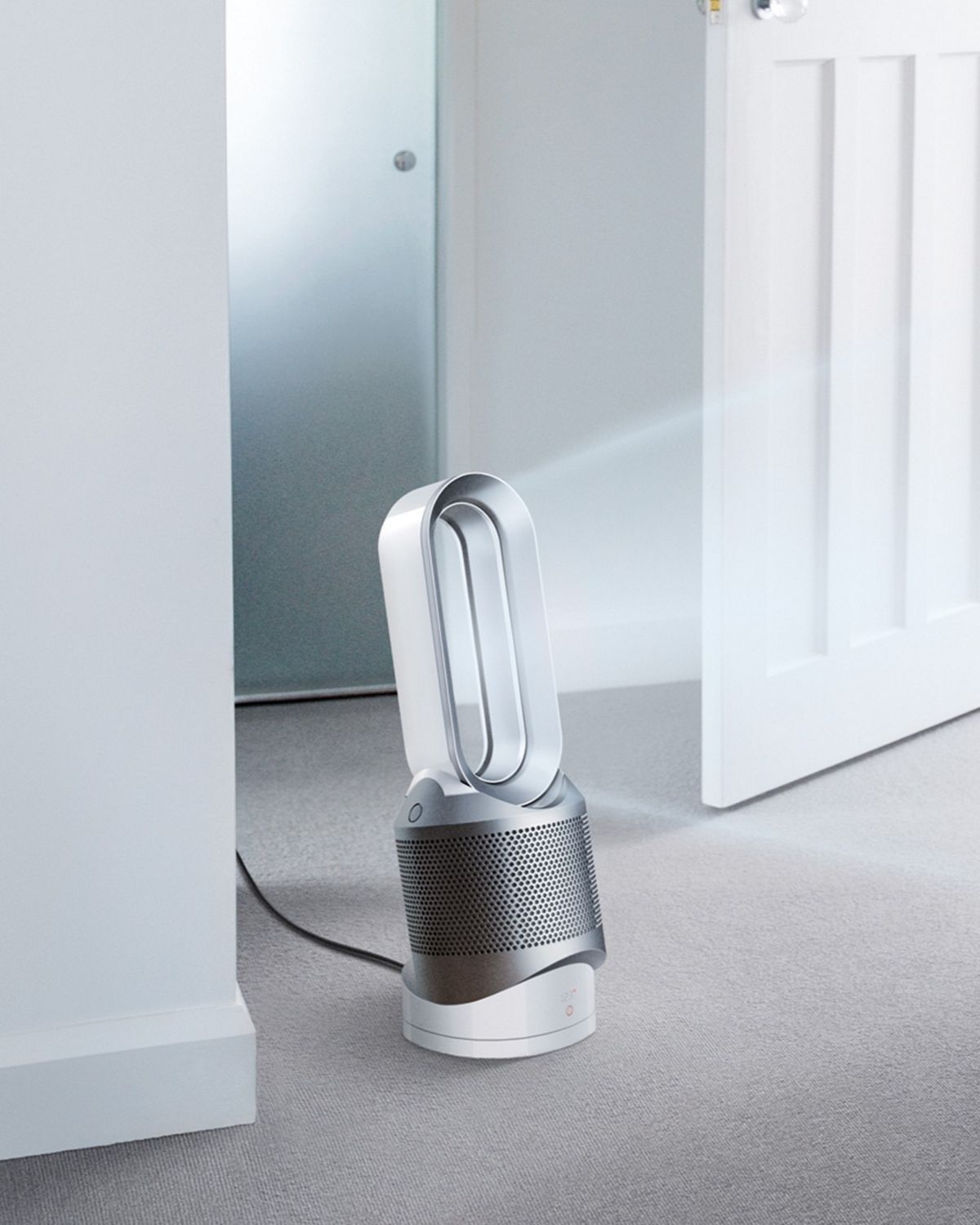 Woman changes baby as the Dyson Hot + Cool purifier purifies the air around them. 