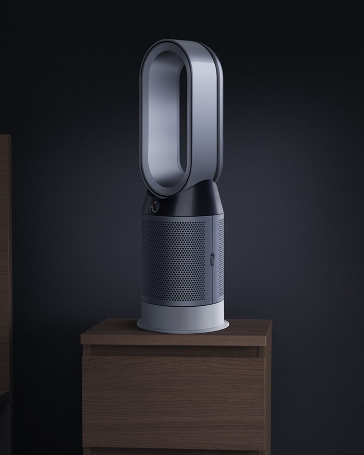 A Dyson Hot + Cool purifier sits on a table during the night. 