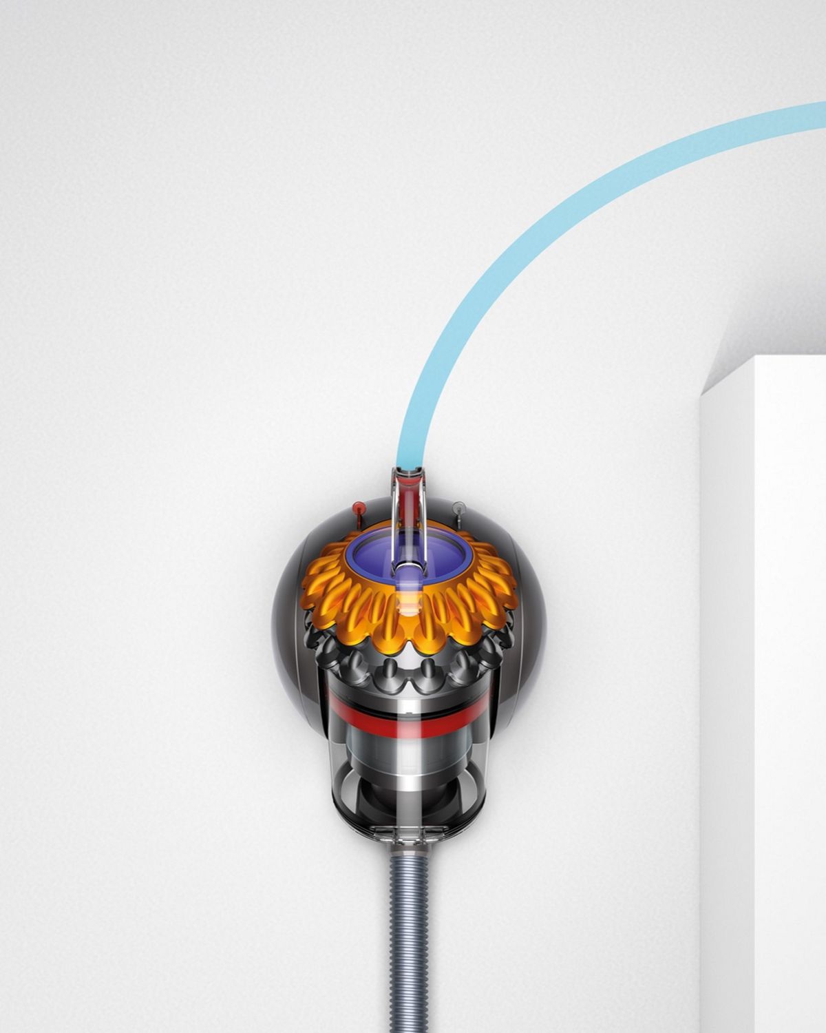 Image showing the Dyson Big ball canister vacuum cleaner easily manoeuvring around a corner.  