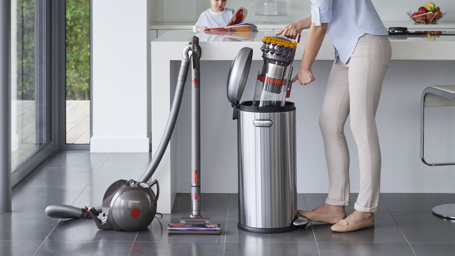 Dyson Big ball canister vacuum cleaner being easily emptied into a garbage bin.
