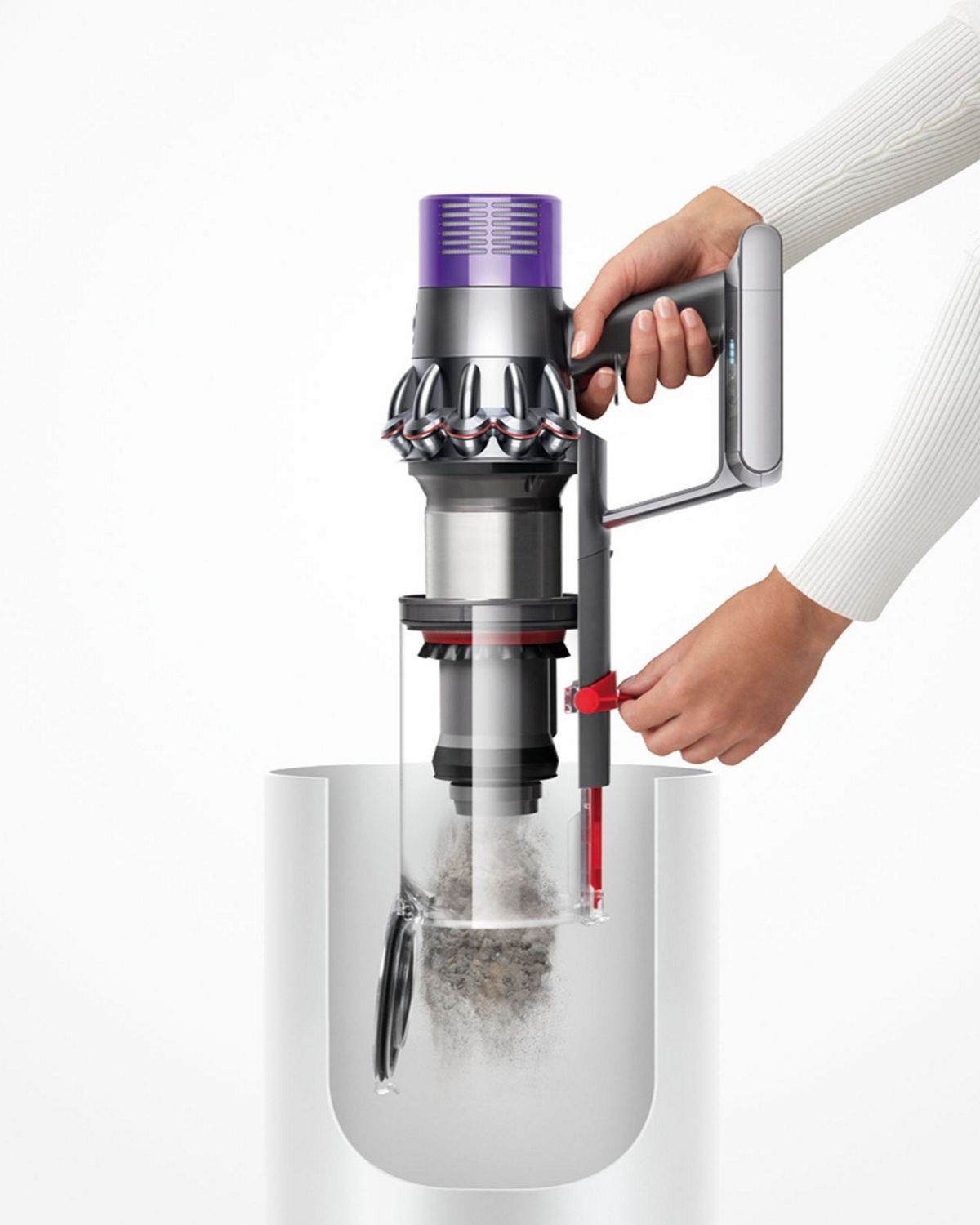 Dyson V10 Animal cordless vacuum cleaner being emptied into bin using the hygienic point and shoot system.